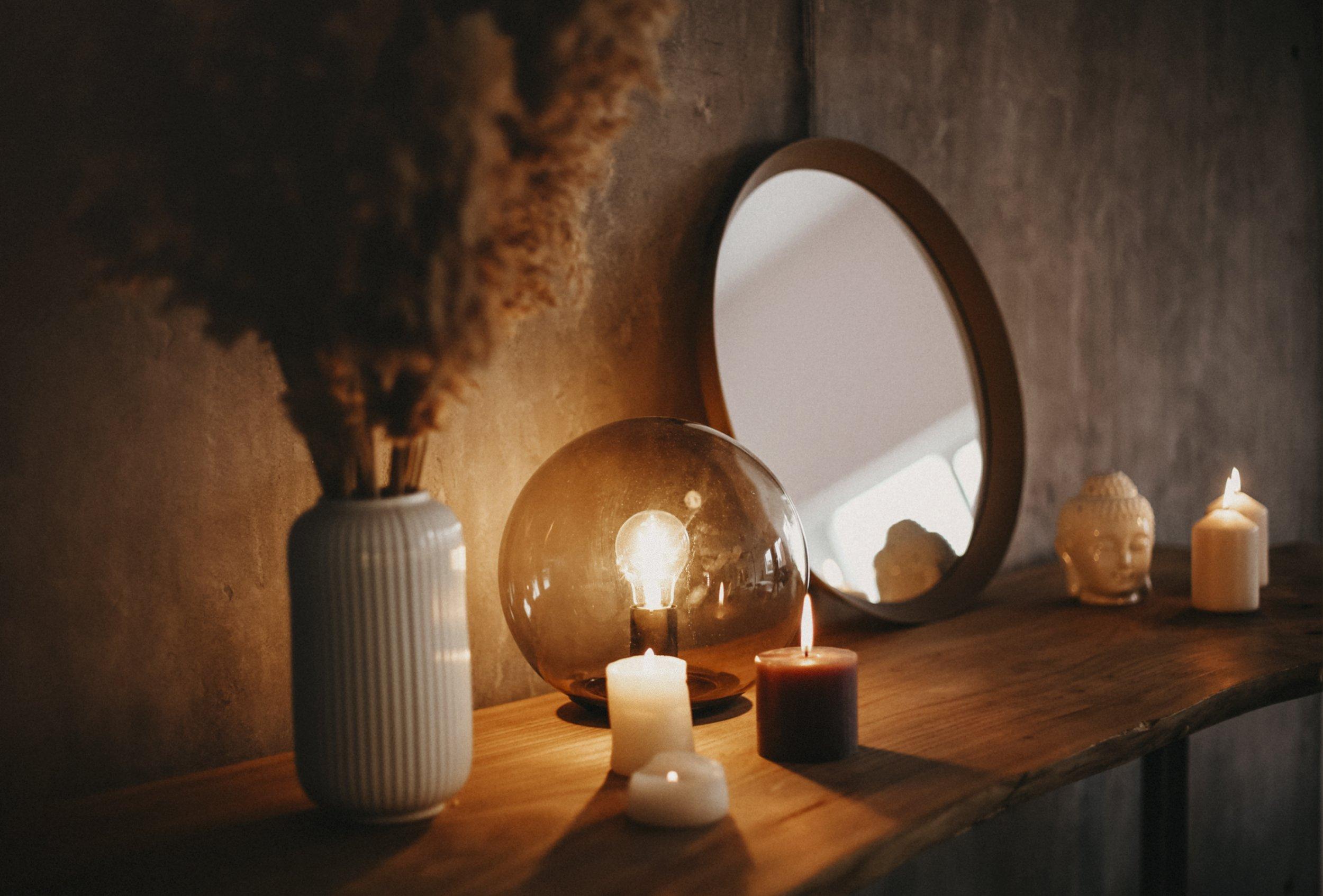 Pools of warm candlelight and lamp glow drawing the room inward