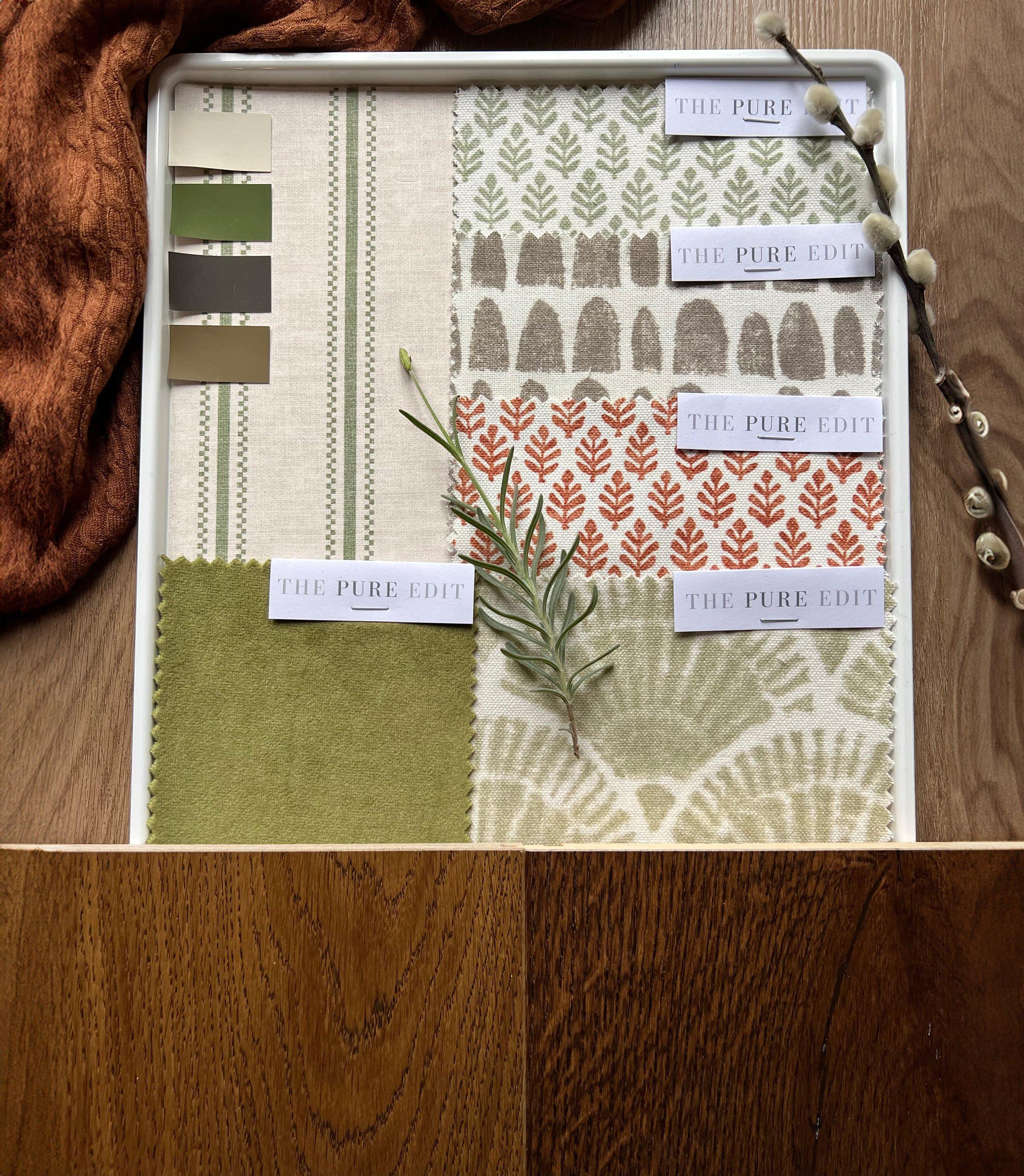 Colour concept board with fabric swatches, paint samples, and natural materials on oak